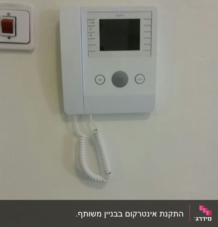 אינטרקום עם מסך ולחצנים על קיר